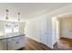 Open-concept kitchen with granite countertops, a functional island, and a view into the adjoining room at 1045 Gaither Nw Pl, Concord, NC 28027