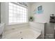 A bathtub beneath a glass block window providing plenty of natural light at 108 Vermillion Loop, Statesville, NC 28625