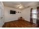Bright bedroom featuring wood-look floors, ceiling fan, and a wall-mounted TV at 108 Vermillion Loop, Statesville, NC 28625
