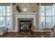 Living room fireplace with decorative mantle, tile surround, and hearth at 108 Vermillion Loop, Statesville, NC 28625