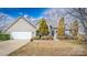 Charming home featuring vinyl siding, a two-car garage, and a professionally landscaped front yard at 108 Vermillion Loop, Statesville, NC 28625