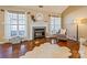 Cozy living room with a fireplace, large windows, and wood floors at 108 Vermillion Loop, Statesville, NC 28625