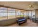 Relax in the sunroom with a ceiling fan, bench seating, and outdoor views for comfort and tranquility at 108 Vermillion Loop, Statesville, NC 28625