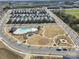 Community aerial view featuring houses, a swimming pool, playground, and walking paths on a sunny day at 11518 Solstice Way, Huntersville, NC 28078