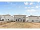 Backyard view featuring houses, a grill, and a patio area with neutral-colored walls at 11518 Solstice Way, Huntersville, NC 28078