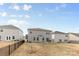 Backyard view featuring houses, a grill, and a patio area surrounded by neutral-colored walls at 11518 Solstice Way, Huntersville, NC 28078