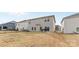 View of the backyard and rear exterior of the house with a grill and patio area at 11518 Solstice Way, Huntersville, NC 28078
