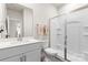 Bright bathroom with a modern vanity, granite countertop, and glass shower stall at 11518 Solstice Way, Huntersville, NC 28078