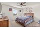 Cozy bedroom featuring a wood-frame bed, ceiling fan, and natural light at 11518 Solstice Way, Huntersville, NC 28078