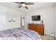 Comfortable bedroom with a dresser and TV, featuring carpeted floors at 11518 Solstice Way, Huntersville, NC 28078
