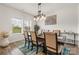 Dining room featuring natural light, modern chandelier, and an elegant table setting with seating for six at 11518 Solstice Way, Huntersville, NC 28078