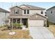 Charming two-story home featuring a brick and vinyl facade, attached garage, and well-maintained landscaping at 11518 Solstice Way, Huntersville, NC 28078