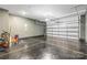 Spacious garage featuring black epoxy flooring with a bright yellow grid, white doors and overhead lighting at 11518 Solstice Way, Huntersville, NC 28078