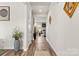 Inviting hallway with hardwood floors and modern decor leading to the living area, offering a seamless transition at 11518 Solstice Way, Huntersville, NC 28078