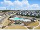 Community pool and playground with a neighborhood of homes in the background on a beautiful day with blue skies at 11518 Solstice Way, Huntersville, NC 28078