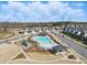 Aerial view of the community pool, playground, and surrounding neighborhood with well-maintained homes at 11518 Solstice Way, Huntersville, NC 28078