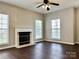 Living room highlighting a fireplace and a ceiling fan at 12044 Brownestone View Dr, Charlotte, NC 28269