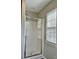 Tiled shower with glass door situated next to a window bringing in an abundance of natural light at 12044 Brownestone View Dr, Charlotte, NC 28269