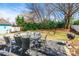 Backyard patio setup with dining table, chairs, and a barbecue grill, perfect for outdoor enjoyment at 1246 Rising Oak Dr, Charlotte, NC 28206
