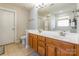 Bright bathroom featuring a double sink vanity with wood cabinets and light countertops at 1246 Rising Oak Dr, Charlotte, NC 28206