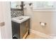 Bathroom with a dark vanity and patterned tiling around the mirror at 1246 Rising Oak Dr, Charlotte, NC 28206