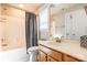 Bright bathroom features a shower-tub combo, vanity with a sink, and a large mirror at 1246 Rising Oak Dr, Charlotte, NC 28206