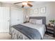 Comfortable bedroom features a patterned bed with a gray headboard, ceiling fan, and closet at 1246 Rising Oak Dr, Charlotte, NC 28206
