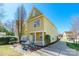 Charming two-story home with a welcoming porch, patio with grill and outdoor seating, and landscaped yard at 1246 Rising Oak Dr, Charlotte, NC 28206