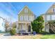 Charming yellow two-story home featuring a welcoming front porch and well-maintained landscaping at 1246 Rising Oak Dr, Charlotte, NC 28206