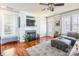 Well-lit living room with a fireplace, large windows, and comfortable seating arrangement at 1246 Rising Oak Dr, Charlotte, NC 28206