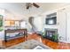 Cozy living room featuring a fireplace with mosaic tile, hardwood floors, and staircase access at 1246 Rising Oak Dr, Charlotte, NC 28206