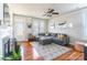 Bright and airy living room with a gray sectional, hardwood floors, and large windows at 1246 Rising Oak Dr, Charlotte, NC 28206