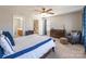 Bedroom with blue and white bedding, soft carpeting, and warm lighting at 1246 Rising Oak Dr, Charlotte, NC 28206