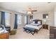 Spacious bedroom featuring neutral walls, ceiling fan, and blue accent furniture at 1246 Rising Oak Dr, Charlotte, NC 28206