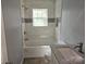 Well-lit bathroom featuring modern tile surround, updated fixtures, and a convenient built-in niche at 126 Lowry St, Chester, SC 29706