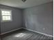 Comfortable bedroom with natural light from the window and modern woodgrain flooring at 126 Lowry St, Chester, SC 29706