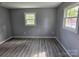 Bright bedroom featuring two windows and modern woodgrain flooring at 126 Lowry St, Chester, SC 29706