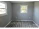 Bright bedroom featuring two windows and modern woodgrain flooring at 126 Lowry St, Chester, SC 29706