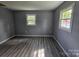 Bright bedroom featuring two windows and modern woodgrain flooring at 126 Lowry St, Chester, SC 29706