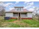 Back exterior of home with metal roof and porch with stairs leading to large backyard surrounded by chain link fence at 1386 Jennings Rd, Statesville, NC 28625