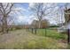 Backyard includes outbuilding, fence with gate, and view of the back exterior with stairs at 1386 Jennings Rd, Statesville, NC 28625