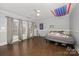 Bedroom featuring hardwood floors, multiple windows, and neutral paint at 1386 Jennings Rd, Statesville, NC 28625