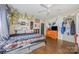 Bedroom featuring hardwood floors, a ceiling fan, and charming decor at 1386 Jennings Rd, Statesville, NC 28625