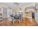 Inviting dining area featuring hardwood floors and an open view into the kitchen with barstool seating at 1386 Jennings Rd, Statesville, NC 28625