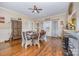 Cozy dining room with hardwood floors and a ceiling fan, adjacent to the kitchen area at 1386 Jennings Rd, Statesville, NC 28625