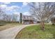 Picturesque home with a curved driveway, featuring a charming porch, metal roof and spacious outdoor area at 1386 Jennings Rd, Statesville, NC 28625