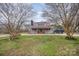 Charming home featuring a classic red roof, inviting front porch and mature trees creating a picturesque setting at 1386 Jennings Rd, Statesville, NC 28625