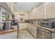 Bright eat-in kitchen with white cabinets, stainless steel appliances, and tile flooring at 1386 Jennings Rd, Statesville, NC 28625
