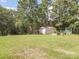 Spacious backyard with a storage shed, mature trees, and plenty of green space at 1755 Simplicity Rd, Concord, NC 28025
