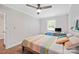 Bright bedroom features hardwood floors, fresh paint, a ceiling fan, and a computer desk by the window at 1755 Simplicity Rd, Concord, NC 28025